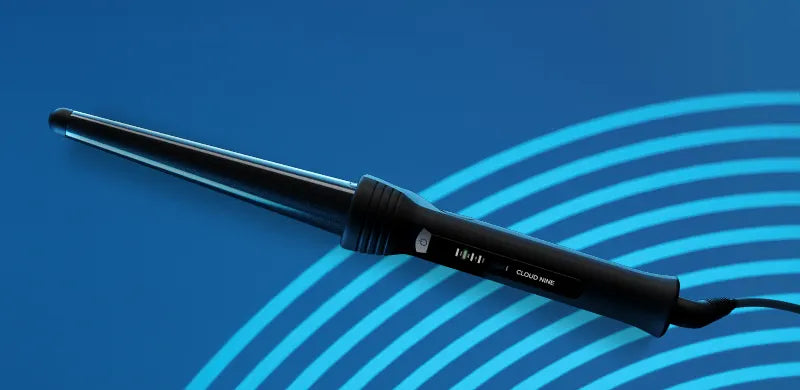 The Curling Wand on a blue patterned background.