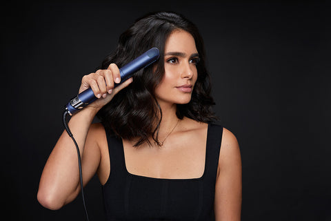 female model holding 2-in-1 Contouring Iron Pro in hand while straighteneing her hair