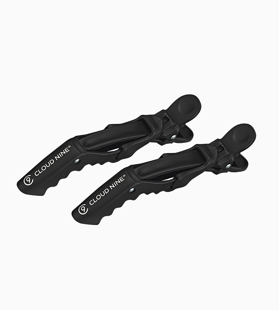 A zoomed out side on image of black CLOUD NINE Crocodile clips on white background. 