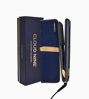 CLOUD NINE Midnight Original Iron standing next to blue velvet style case with gold trim and ribbon next to it's outer box in midnight blue with gold trim