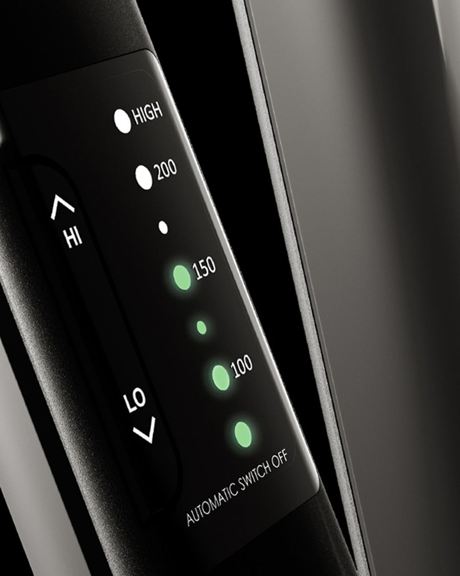 Close-up of the variable temperature control panel on a black CLOUD NINE straightener on a black background. 