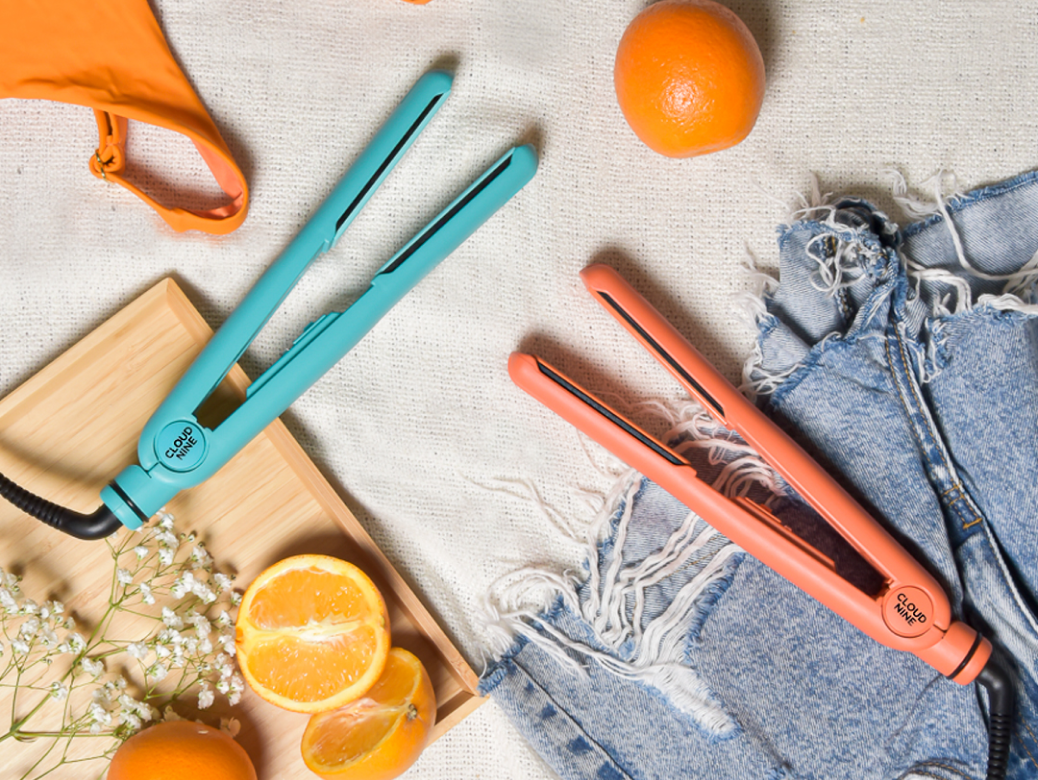 The Soda Fountain Blue and Motel Sunset Mandarin Retro Irons laying on a summer themed background with oranges, a bikini top and denim shorts.
