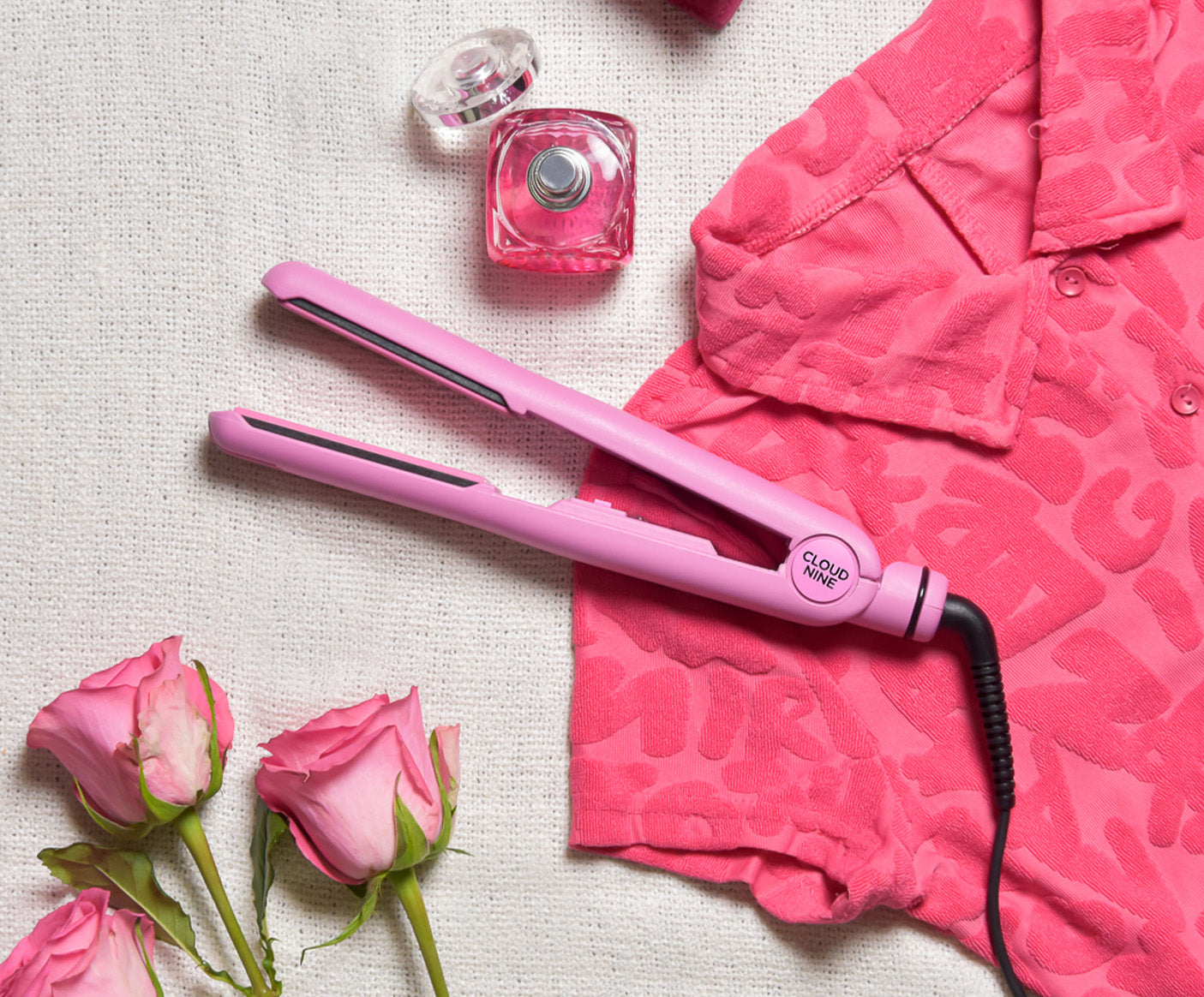 Poodle Skirt Pink Retro Iron surrounded by other pink items including pink roses, pink perfume and a pink button-up shirt.