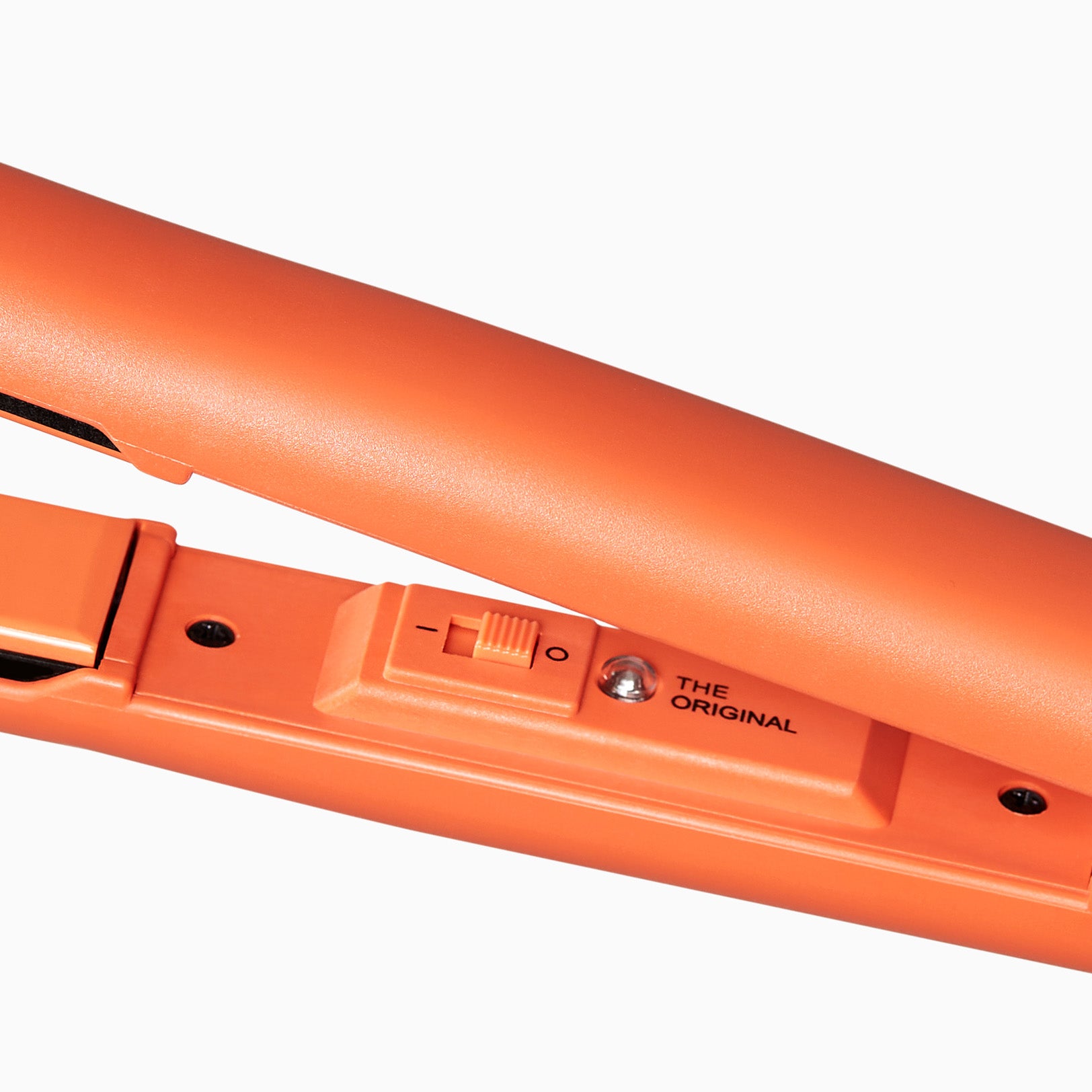 Close up of the retro power on button on the Motel Sunset Mandarin Retro Iron.