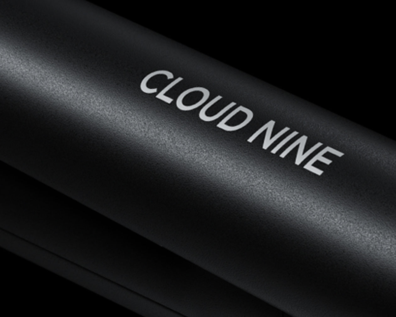 Close up of the white CLOUD NINE branding on the black Original Cordless Iron.