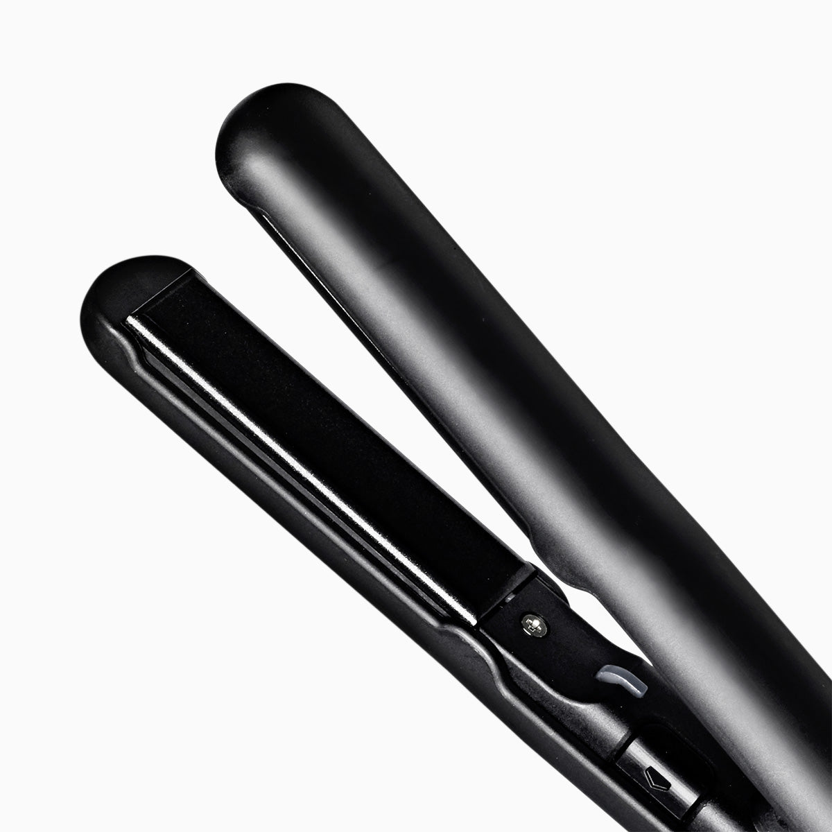 Close-up of black CLOUD NINE Micro Iron's floating ceramic plates on a white background.