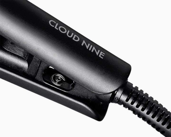 Close-up of black CLOUD NINE Micro Iron at the hinge with view of cord.