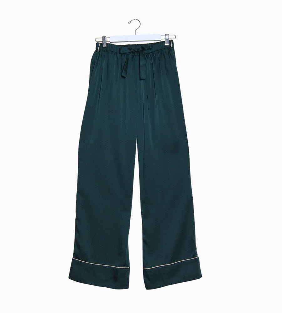 Close up of the dark green pyjama trousers, featuring a bow on the waist.