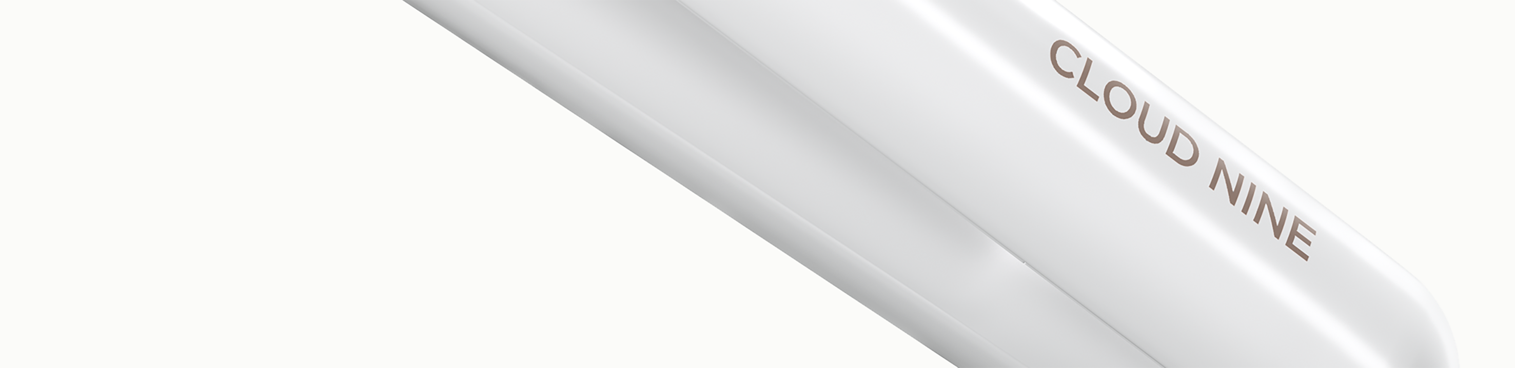 Close up of the CLOUD NINE branding on a white hair straightener on a white background.