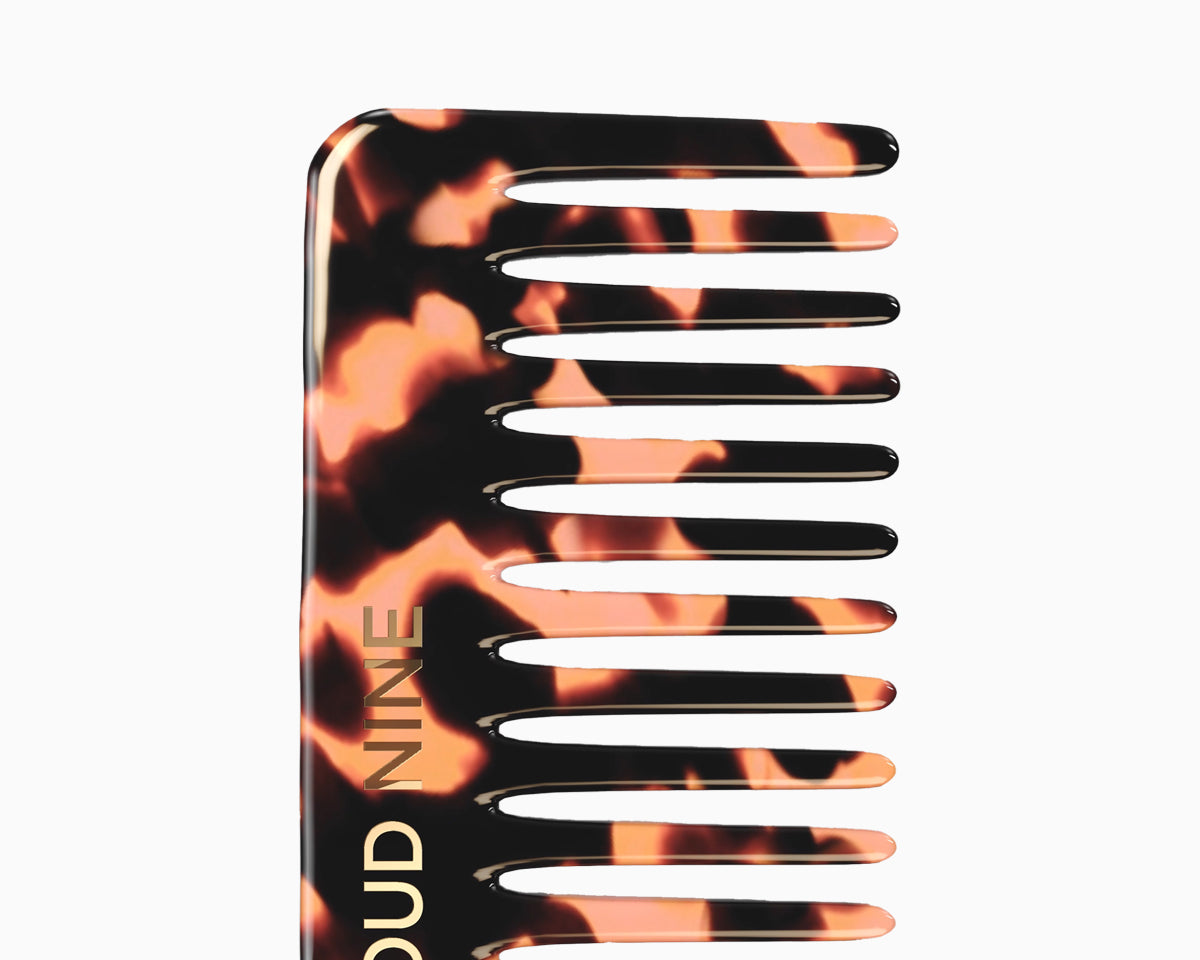 Close up of the top of a CLOUD NINE texture comb in tortoise shell.