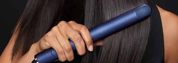 close up shot of model straightening her hair with the 2-in-1 contouring iron pro