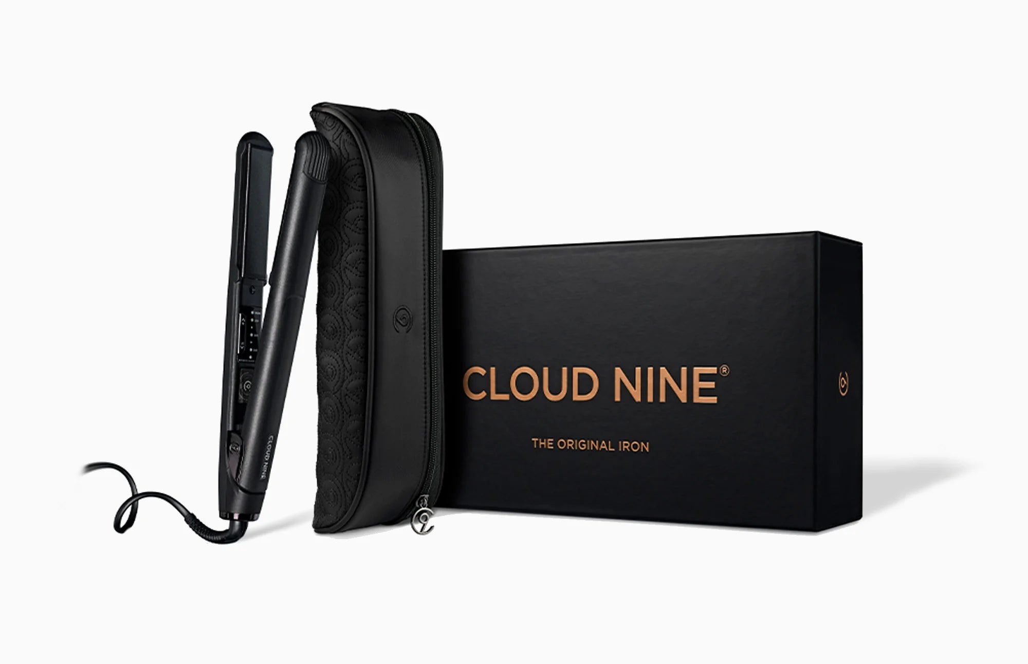 The CLOUD NINE Original Iron and styling case leaning on the black packaging box.