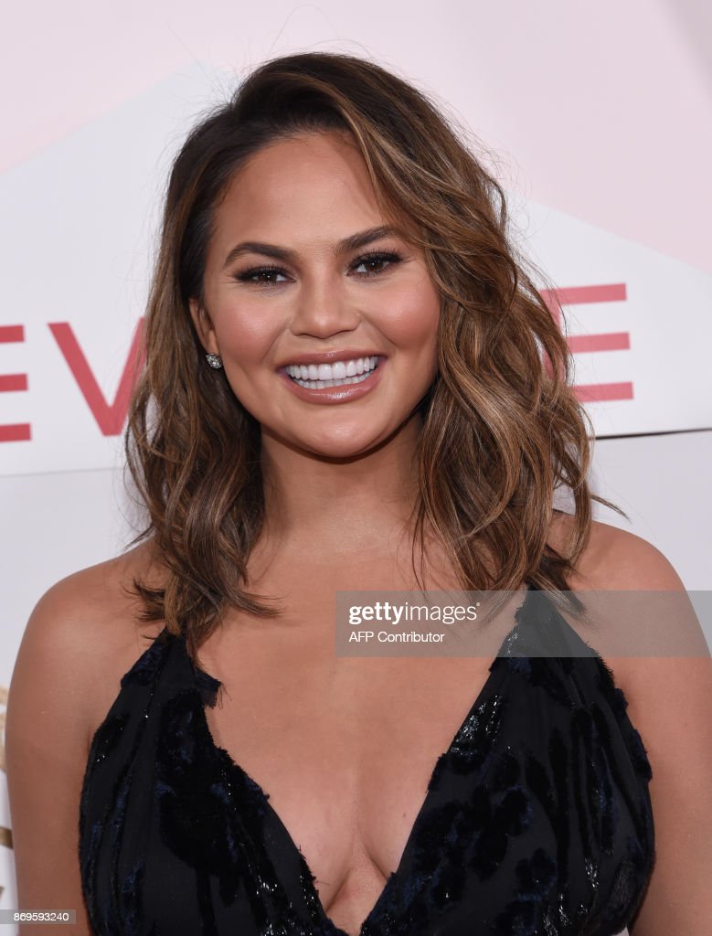 Image of Chrissy Teigen with brown curly hair.