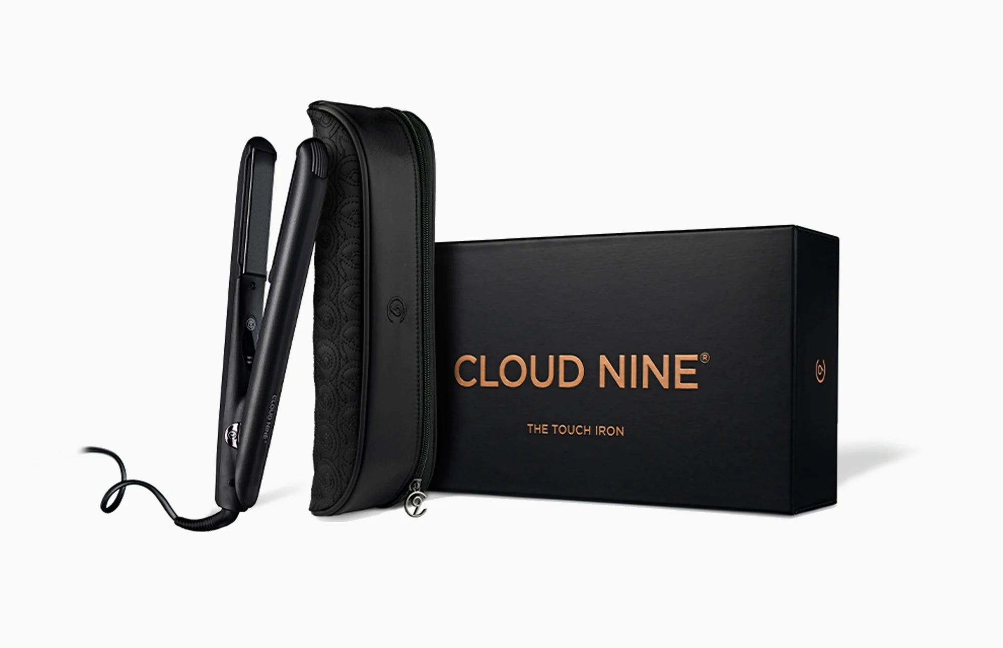 The CLOUD NINE Touch Iron and styling case leaning on the black packaging box.