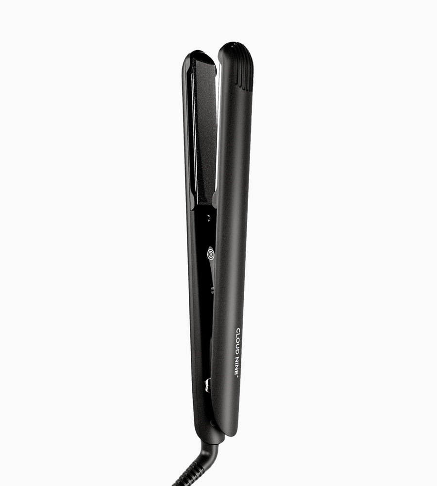 A black Touch Iron hair straightener.