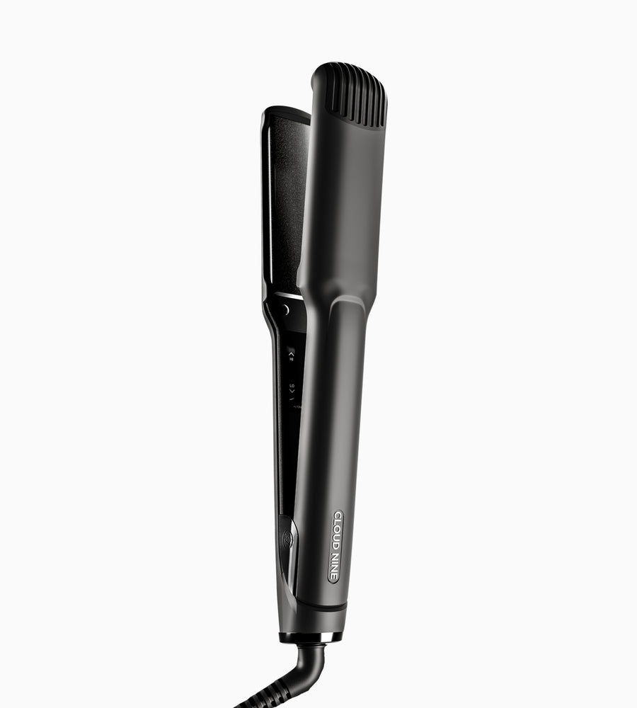 An upright black Wide Iron hair straightener.