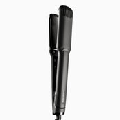 A black Wide Iron hair straightener.