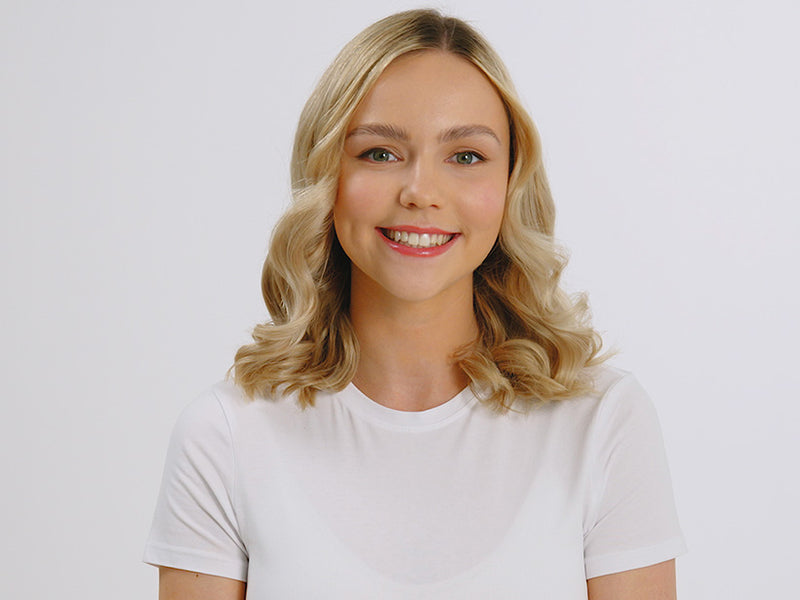 Model with short curly blonde hair styled with the Cordless Iron.