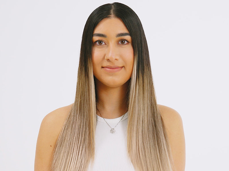 Model with long straight blonde hair and dark roots style with The Hot Brush.