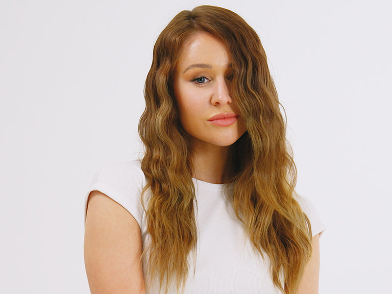 Model with long brown wavy hair styled using the Original Iron Pro.