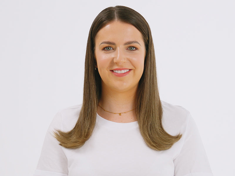 Model with mid-length brown hair that flicks up at the ends styled with The Wide Iron.