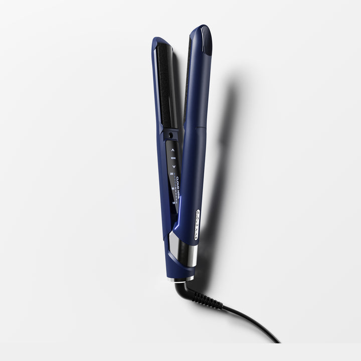 The Contouring Original Iron turned on and angled towards the screen with promotion for Free Travel Hair Dryer worth £99.