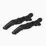 A zoomed out side on image of black CLOUD NINE Crocodile clips on white background. 