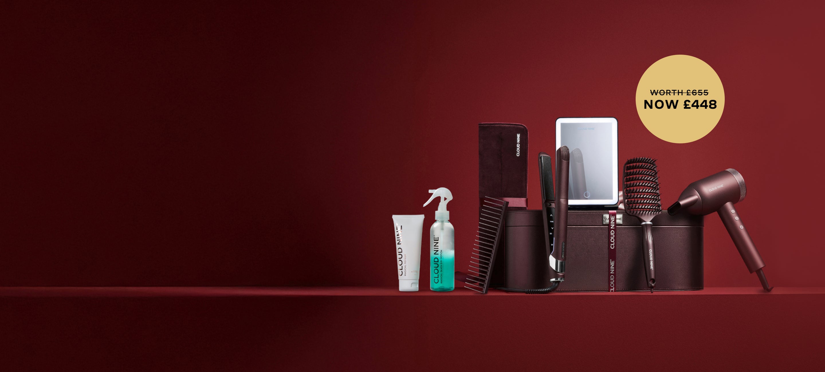 Set of Cloud Nine Dark Burgundy hair styling tools including a straightener and dryer, alongside free gifts including a brush, comb and vanity mirror. With a gold roundel showing now £448 but worth £655.