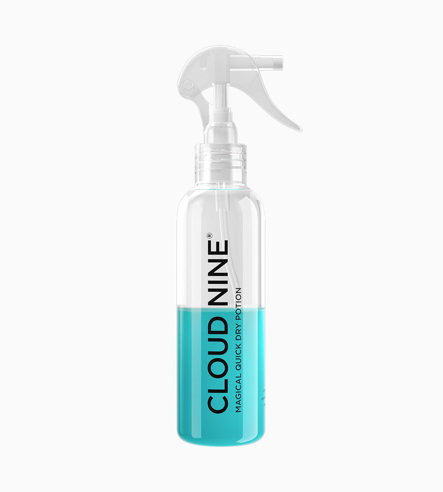 A zoomed out image of 200 ml bottle of CLOUD NINE Magical Quick Dry Potion before ingredients are mixed. The top of bottle is clear and the bottom half is turquoise.