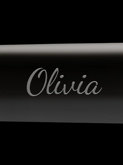 A black hair straightener with the name Olivia monogrammed.