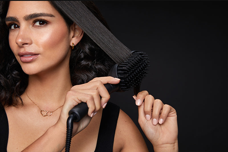 Model straightening her short, curly hair with the Hot Brush.