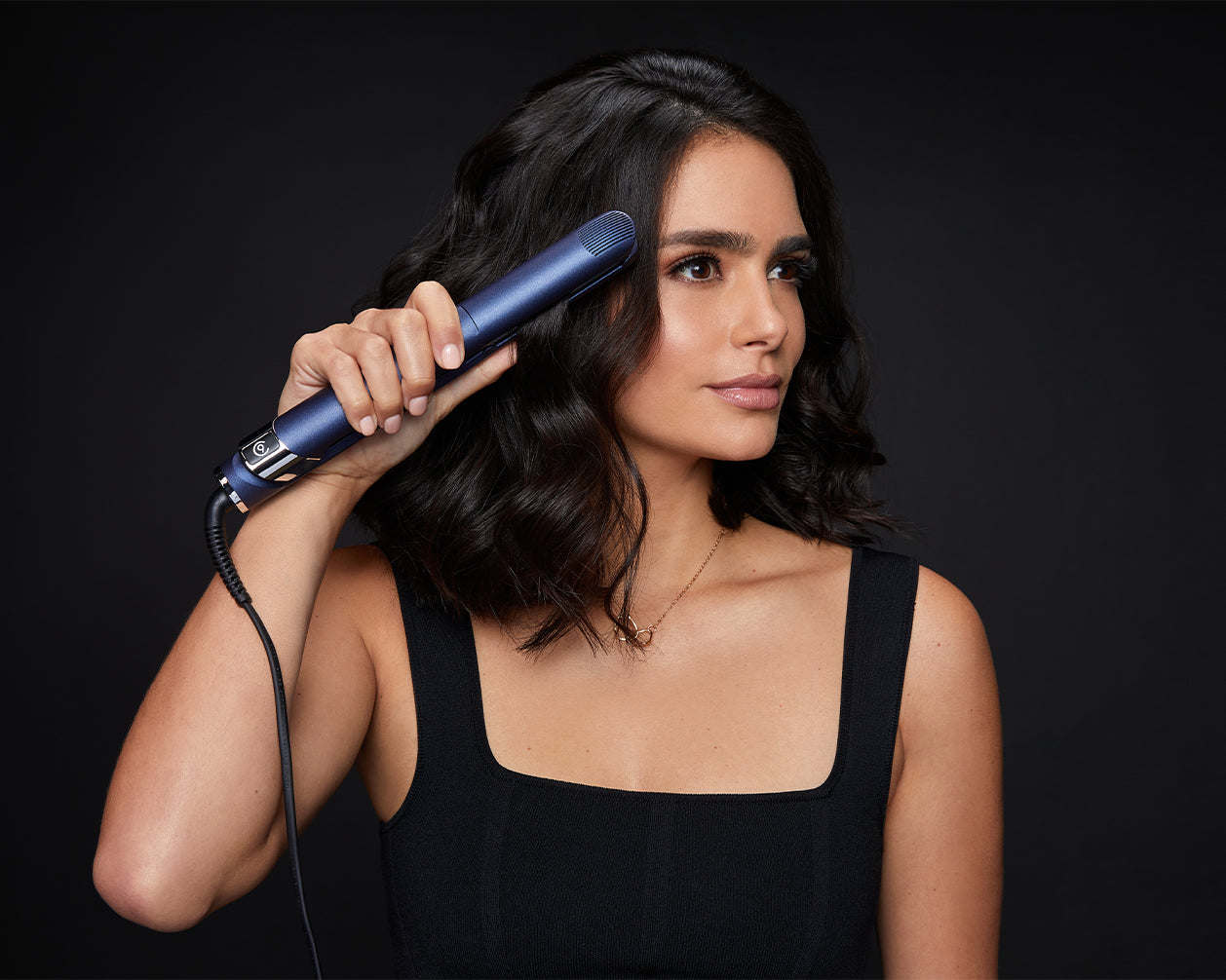 Model curling her short black hair with the 2-in-1 Contouring Iron Pro.