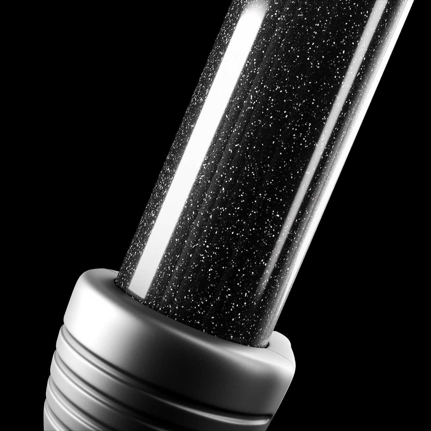 Close-up image of the mineral infused ceramic barrel of black CLOUD NINE Curling Wand on a black background.