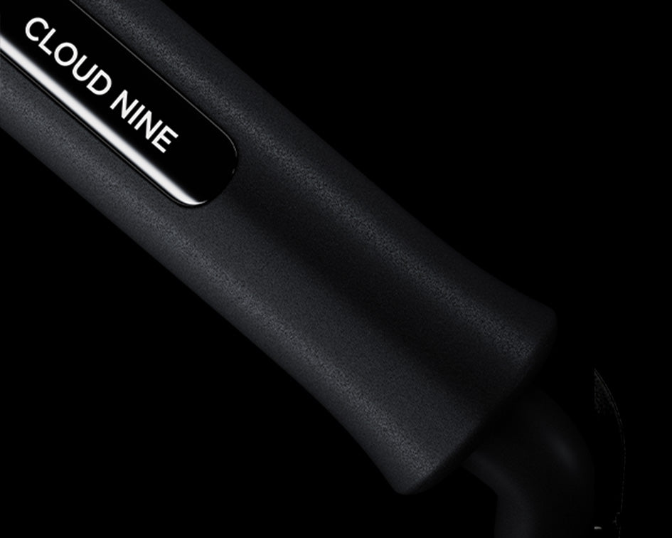 Close up of the white CLOUD NINE branding on the handle of the black Waving Wand.