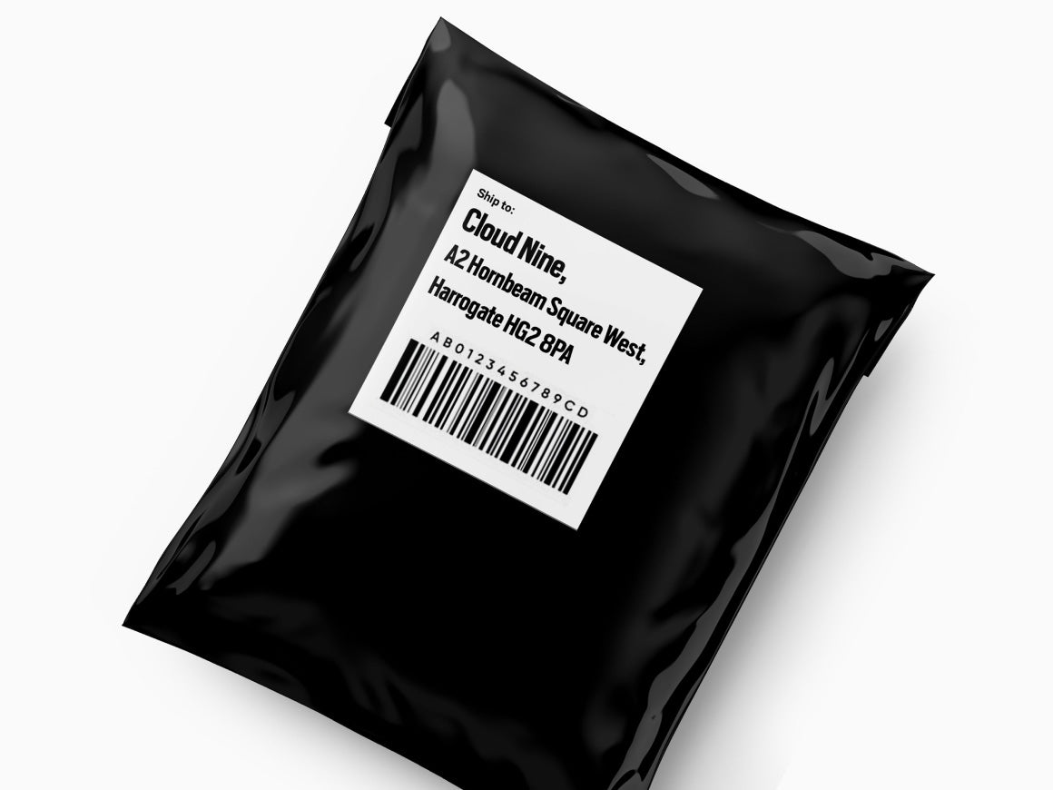 Image of black postage packaging with a white label with CLOUD NINE address on.
